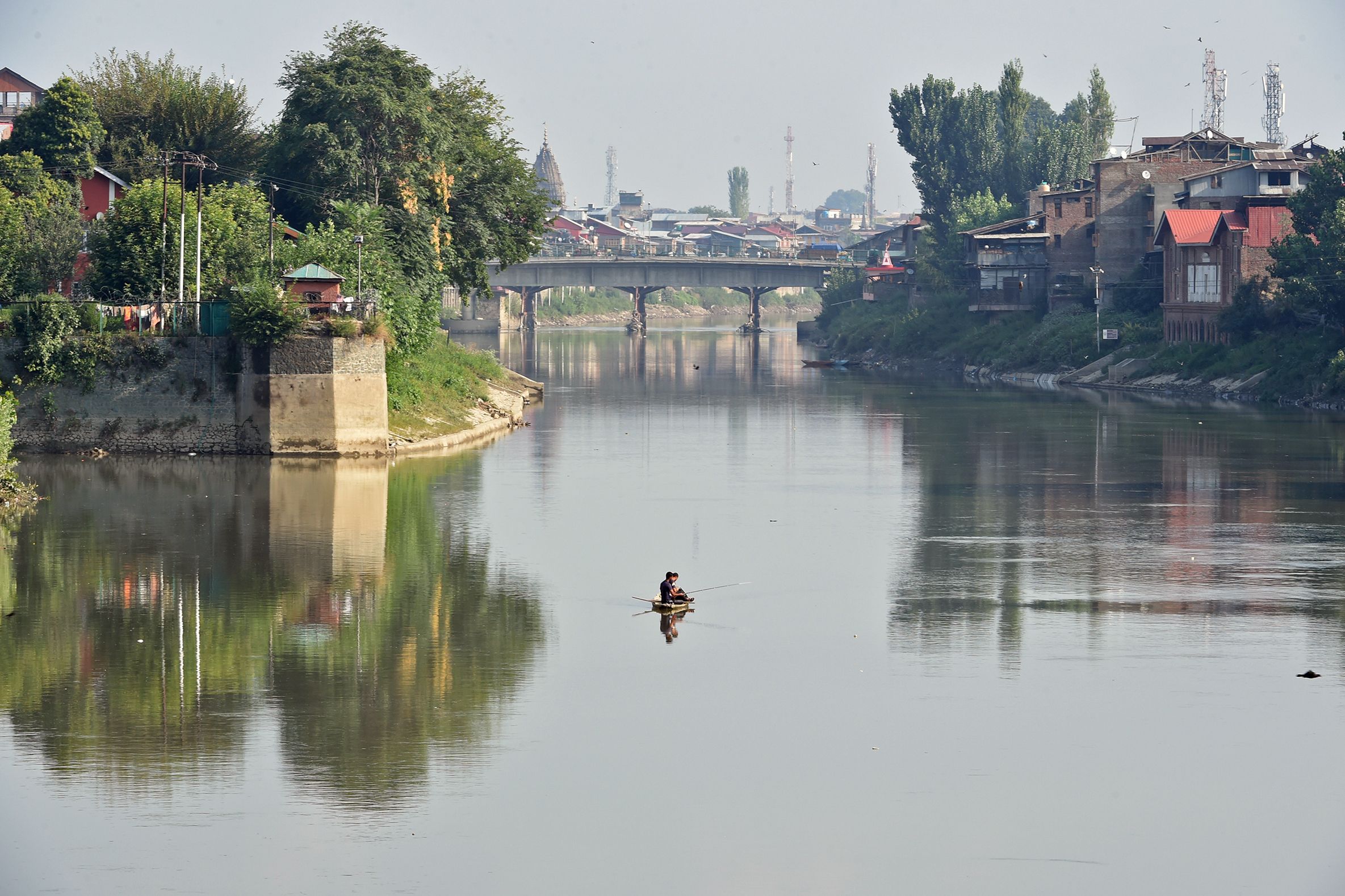 Men fish in Dal Lake in Srinagar on August 25, 2019. (AFP)