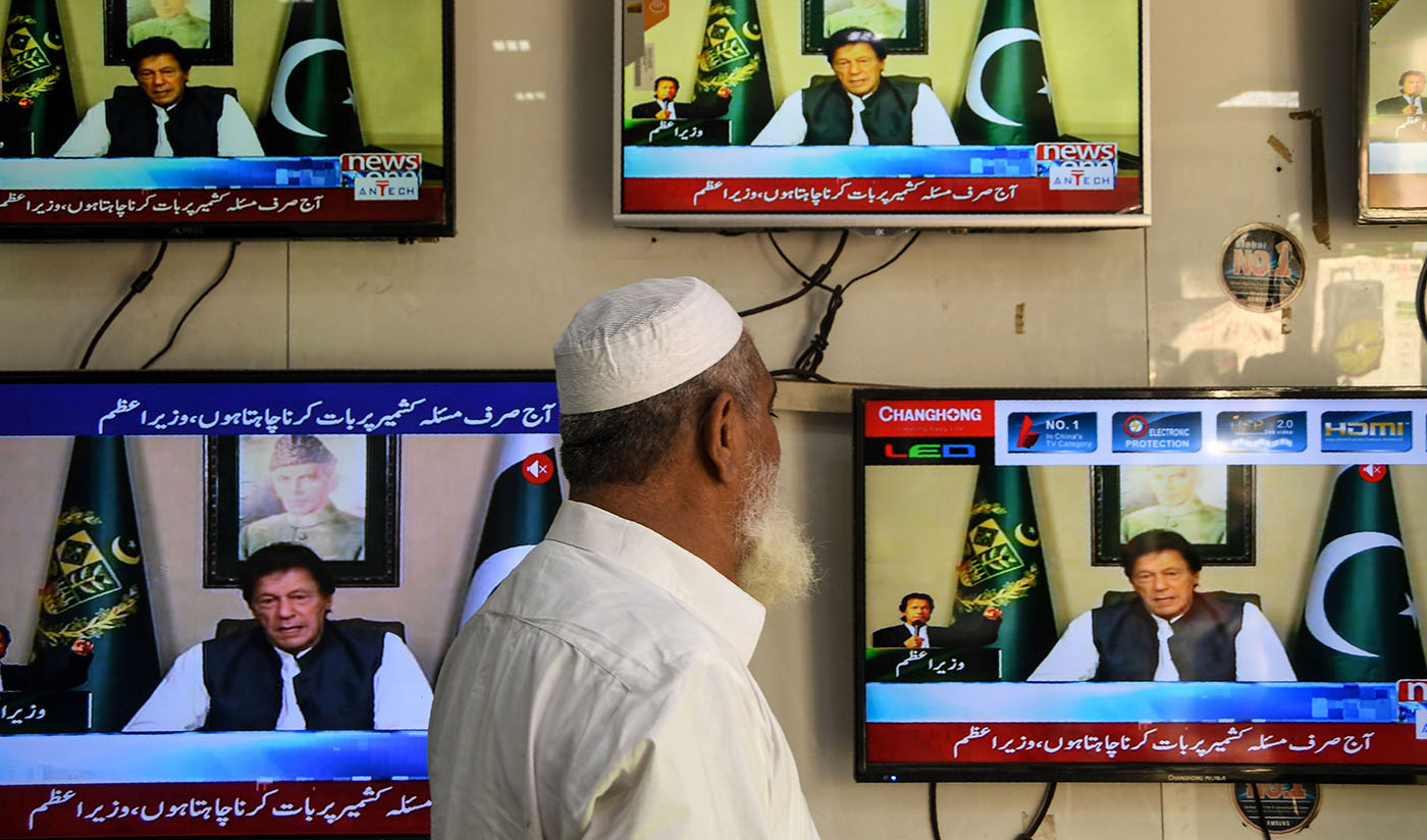 A man watches television as Pakistan's Prime Minister Imran Khan speaks to the nation on disputed Kashmir issues, at an electronic market in Karachi on Aug. 26, 2019. (AFP)