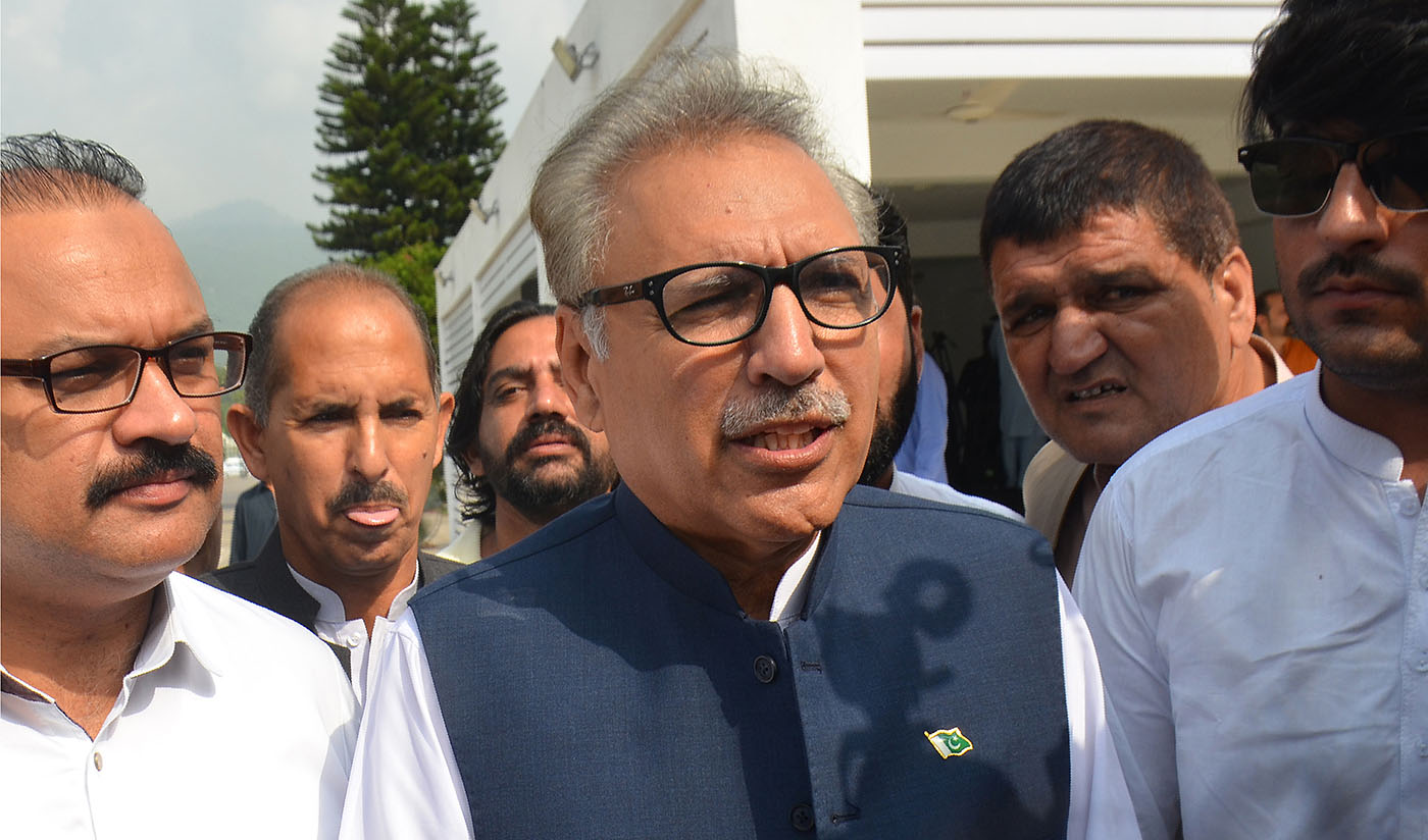 Pakistan’s President Dr. Arif Alvi is the latest to join the list of Pakistanis to receive a notice from Twitter that their post has garnered enough reports for the micro-blogging site to look into it. (AFP)
