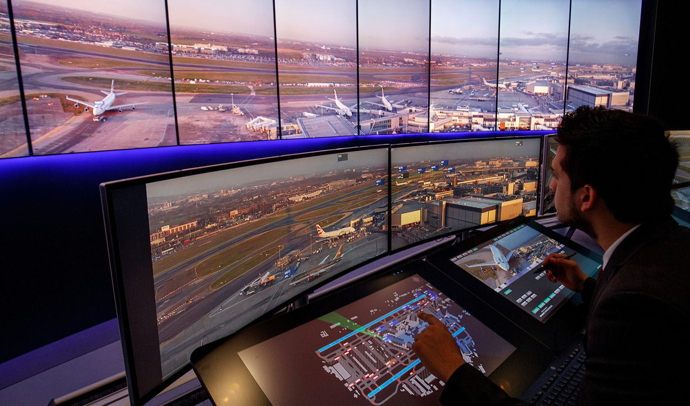 In this file photo, Air Traffic Control Engineers use screens displaying real-time panoramic views of the runways and docking gates, as they work on a non-operational trial in the NATS Digital Tower Laboratory, inside the control tower at London Heathrow Airport in west London on Jan. 23, 2019. (AFP)