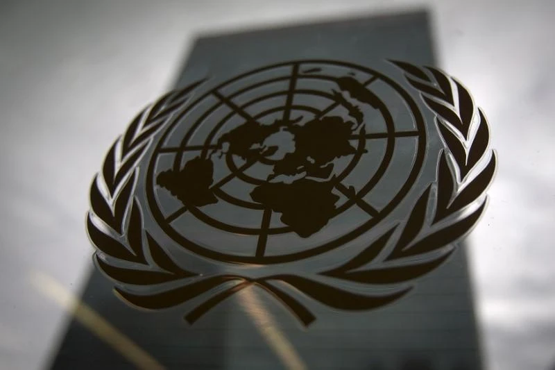 The United Nations headquarters building is pictured though a window with the UN logo in the foreground in the Manhattan borough of New York August 15, 2014. (Reuters)