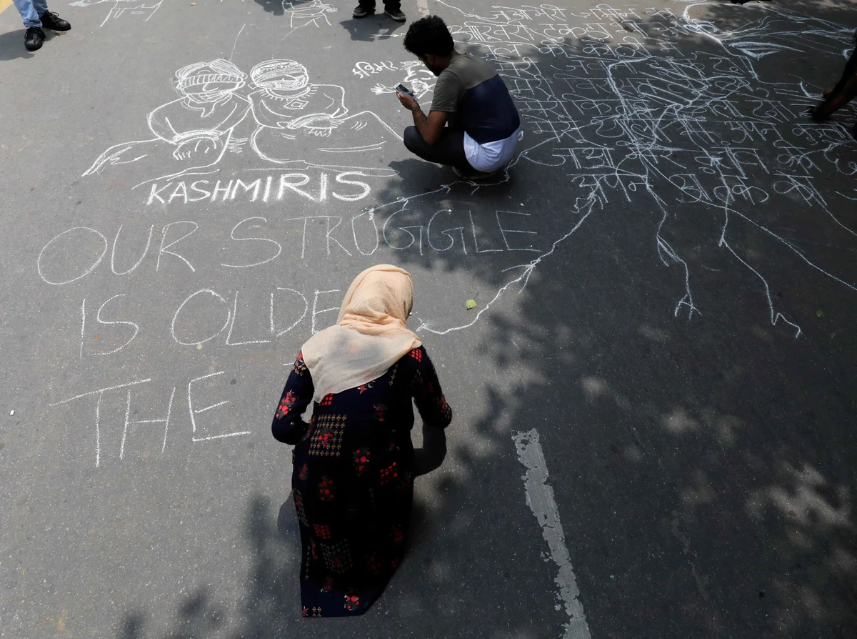 People draw and write messages on a road during a protest against the scrapping of the special constitutional status for Kashmir by the government, in New Delhi, India, August 7, 2019. (Reuters)