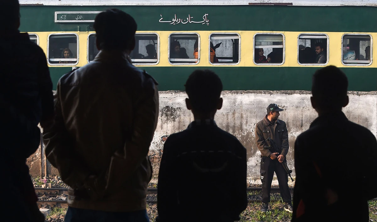 In this file photo, a Pakistani policeman stands guard near the Samjhota Express train traveling to India at Lahore railway station on Feb. 25, 2019. (AFP)