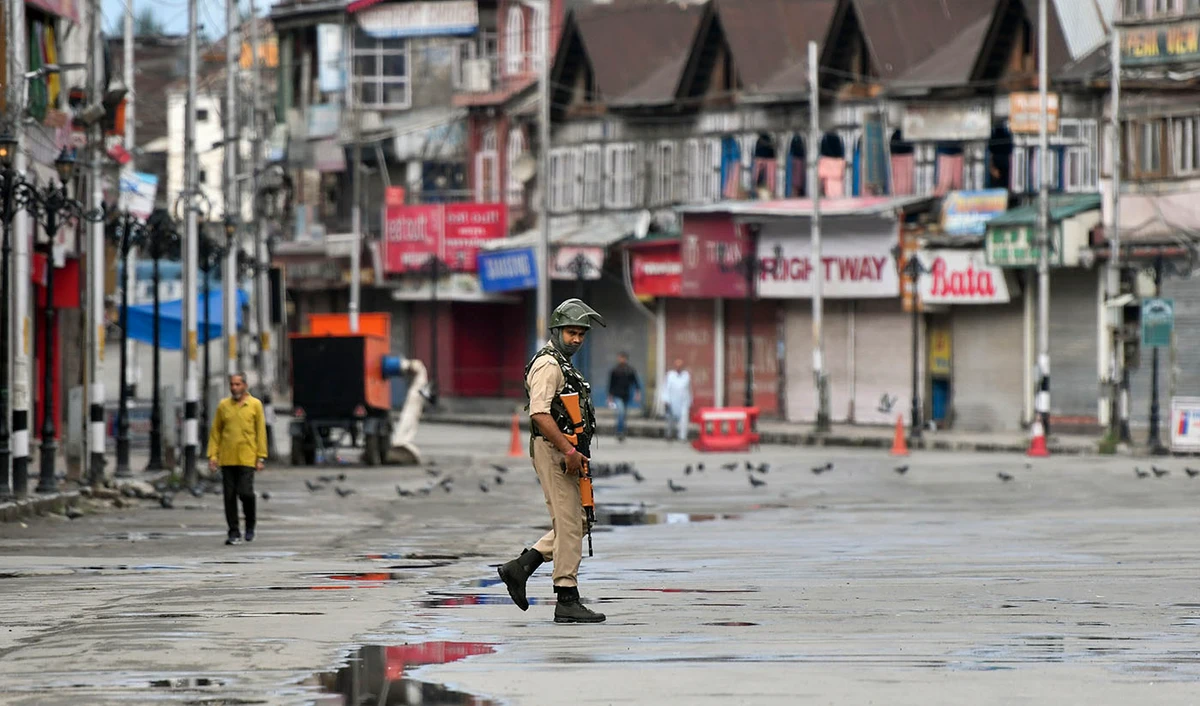 In this file photo taken on August 19, 2019, a security personnel patrols on a deserted road of the Lal Chowk area in Srinagar. (AFP)
