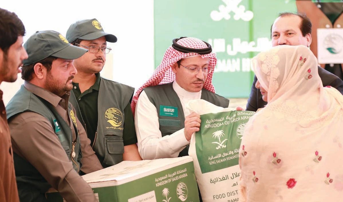 A KSRelief official distributes food packets in Islamabad on April 30, 2019. (Photo Courtesy: KSRelief)