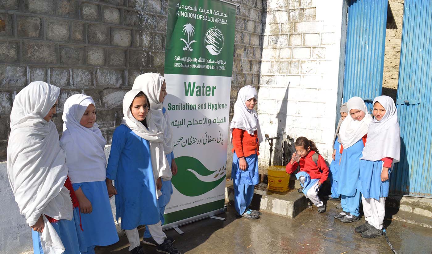 In this January 23, 2019 photo, a young schoolgirl drinks water from a hand pump, surrounded by other students. More than 350 drinking water projects have been completed by KSRelief across Pakistan in recent years. (Photo Courtesy: KSRelief)