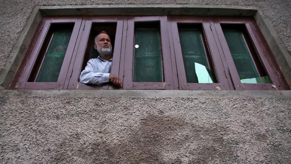 A Kashmiri man looks out from a window of his house which was allegedly damaged by Indian security forces after clashes between protesters and the security forces on Friday evening, during restrictions after the scrapping of the special constitutional status for Kashmir by the Indian government, in Srinagar Aug. 17, 2019. (REUTERS/File)