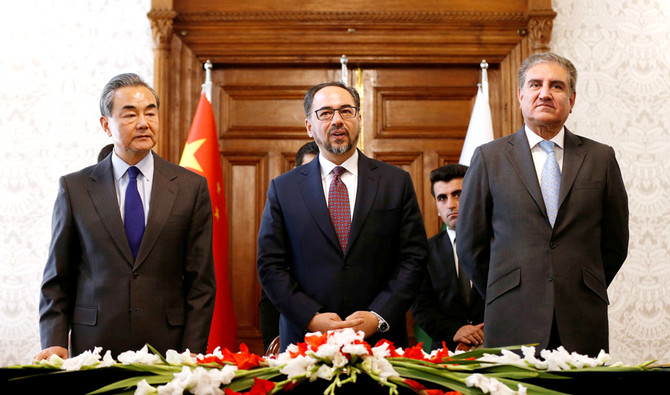 Afghanistan's Foreign Minister Salahuddin Rabbani, Pakistan's Foreign Minister Shah Mehmood Qureshi and Chinese Foreign Minister Wang Yi look on after signing a memorandum of understanding on cooperation in fighting terrorism in Kabul, Afghanistan on Dec. 15, 2018. (REUTERS)