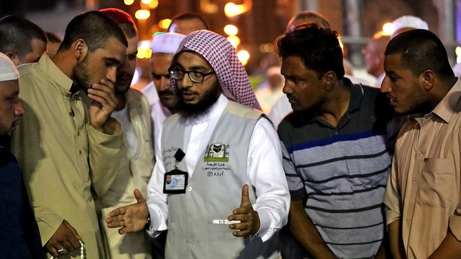 In this file photo, Muslim pilgrims speak to an Urdu translator in Makkah during Hajj on Aug. 17, 2018. (AFP)