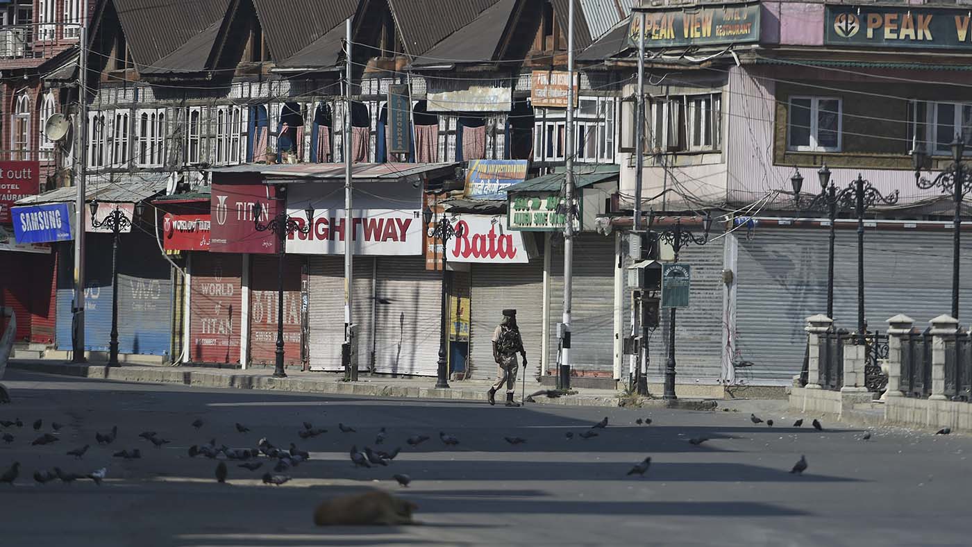 An Indian paramilitary trooper patrols along an empty street during a strict curfew in Lal Chowk area of Srinagar on the 8th day of Muharram on Sept. 8, 2019. (AFP/File)