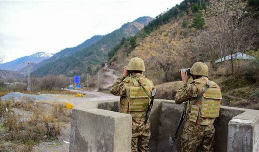 In this file photo, a Pakistani soldiers watch over potential Indian troop movements with binoculars in a bunker at the Chakothi post, some 52 km from Muzaffarabad near their border on February 23, 2019. (AFP)
