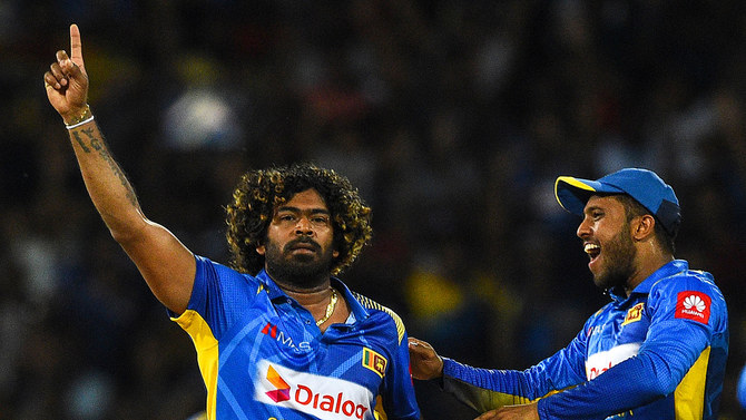 Sri Lankan cricketer Lasith Malinga, left, celebrates with teammates after dismissing Bangladesh captain Tamim Iqbal during the first One Day International (ODI) cricket match between Sri Lanka and Bangladesh at the R.Premadasa Stadium in Colombo on July 26, 2019. (AFP)