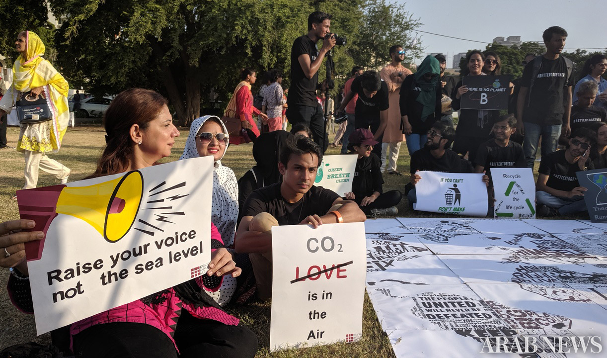 A group of students hold placards with different slogans about the climate change in Karachi's Frere Hall area on Sept 20, 2019. (AN Photo)