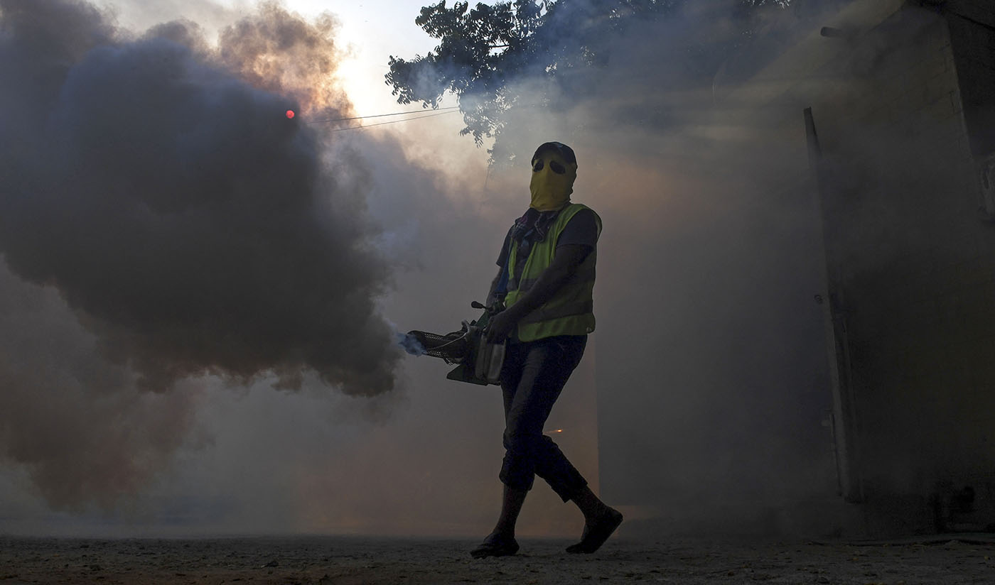 A worker fumigates to kill mosquito larvaes to fight against the spread of dengue fever at a residential area of Karachi on Sept. 20, 2019. (AFP)