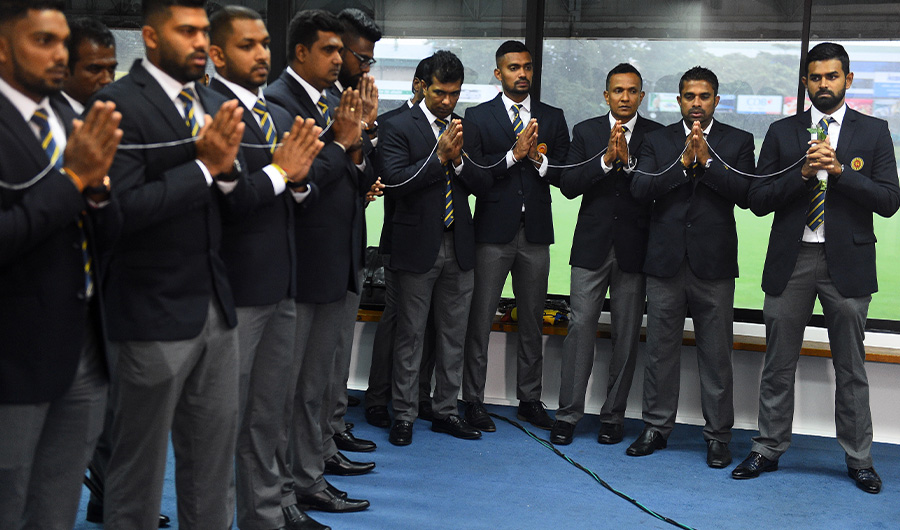 Sri Lanka's cricket captain Lahiru Thirimanne (R) and teammates look on as Buddhist monks chant prayers for their success during a ceremony in Colombo on Septemer 24, 2019, prior to the team's departure for a cricket tour in Pakistan. Sri Lanka's cricket board on September 19 said it will go ahead with its tour of Pakistan despite fears that players could be the targets of terror attacks during the six-match visit. (AFP)