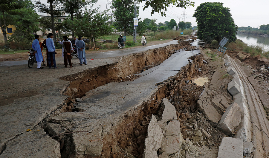 People gather near a damaged road after an earthquake in Mirpur, Pakistan September 25, 2019. (REUTERS)