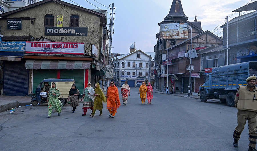 Kashmiri women walk in a street during a lockdown at Amira Kadal in Srinagar on September 27,2019. (AFP)