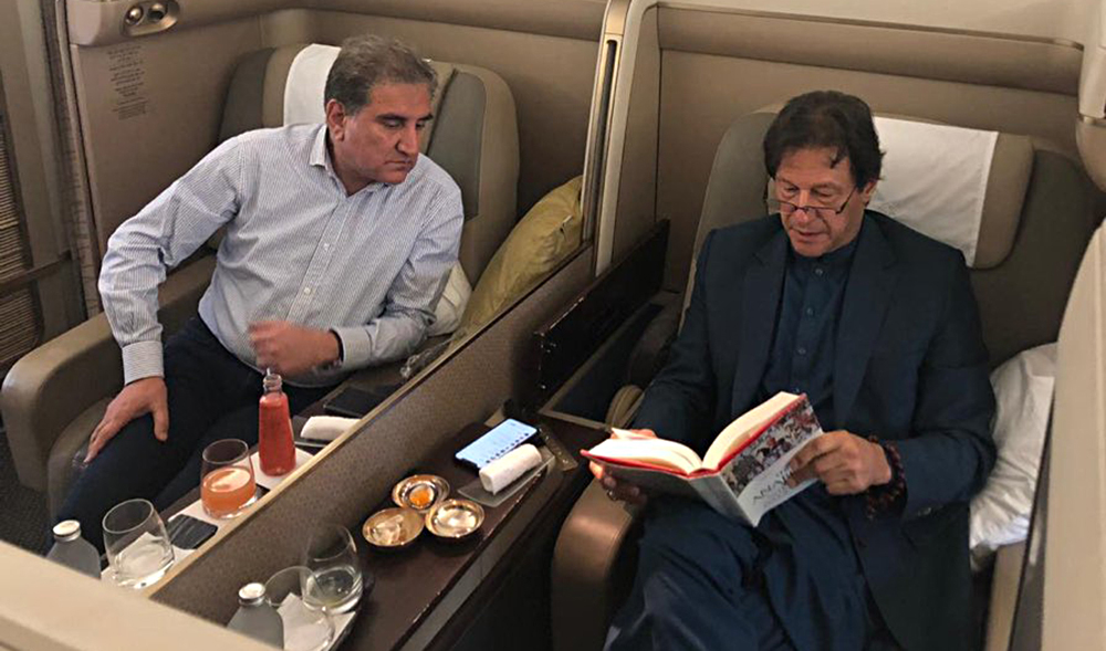 Pakistan's prime minister Imran Khan and Foreign Minister Shah Mahmood Qureshi onboard a commercial flight on Sept. 28, 2019. (Photo courtesy: PTI/Twitter)