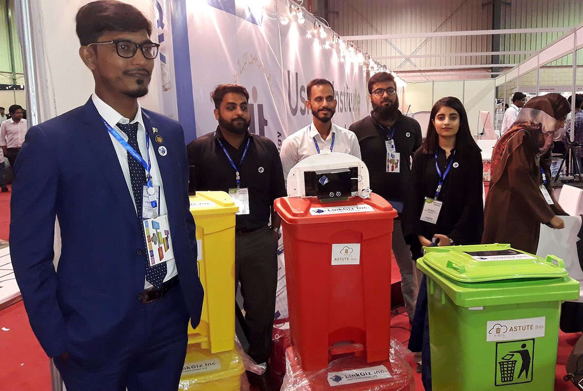 Syed Shahrooz Shamim, founder and CEO of tech start up, LinkGiz, with his team and their project, smart bins, at Karachi’s Expo Center on September 17, 2019. (AN photo)