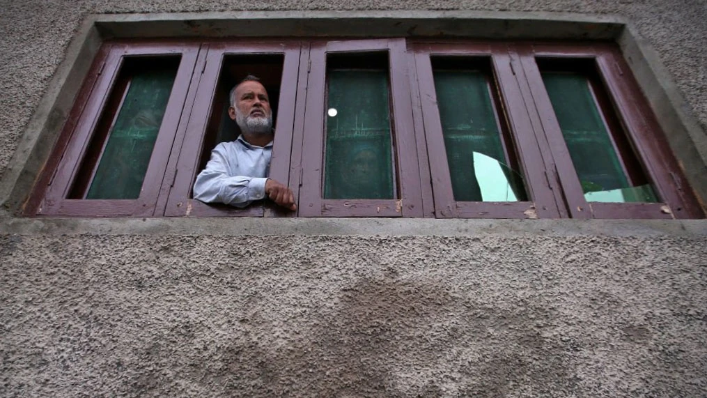 A Kashmiri man looks out from a window of his house which was allegedly damaged by Indian security forces after clashes between protesters and the security forces on Friday evening, during restrictions after the scrapping of the special constitutional status for Kashmir by the Indian government, in Srinagar Aug. 17, 2019. (REUTERS/File)