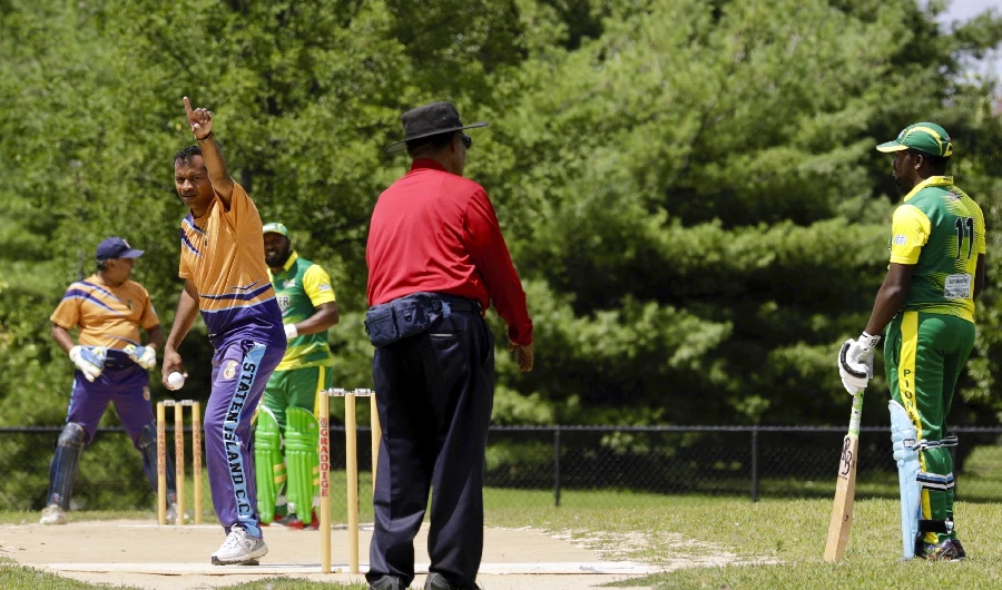Image Caption : In this Sunday, Aug. 11, 2019 photo, Staten Island Cricket Club bowler gestures during a match against Pioneer Cricket Club in the Brooklyn borough of New York. Despite their familiar languages, Staten Island CC, unlike most other teams on the New York City cricket circuit, does not have a dominant religion or ethnicity. (AP Photo)