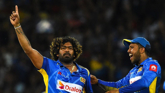 Sri Lankan cricketer Lasith Malinga, left, celebrates with teammates after dismissing Bangladesh captain Tamim Iqbal during the first One Day International (ODI) cricket match between Sri Lanka and Bangladesh at the R.Premadasa Stadium in Colombo on July 26, 2019. (AFP)