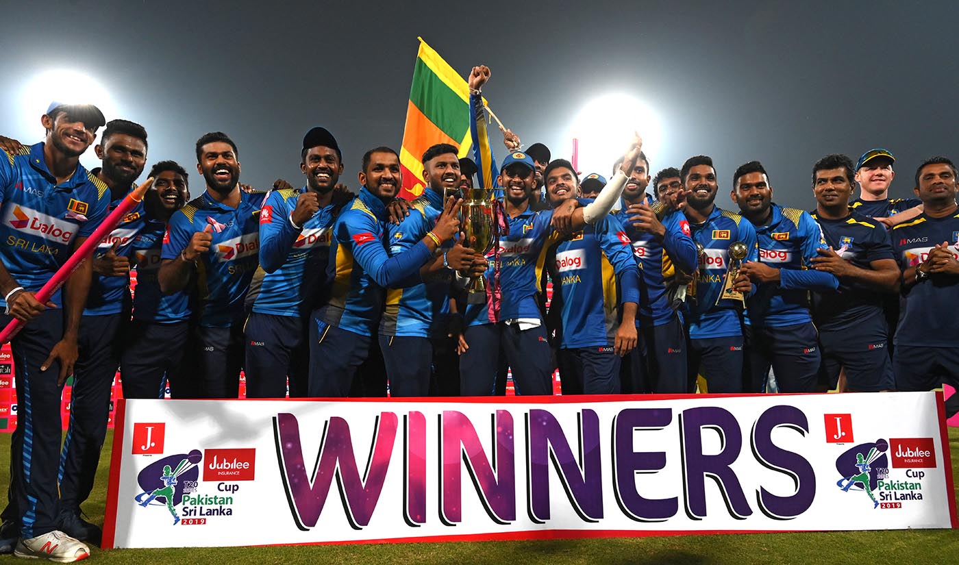 Sri Lankan players pose for a photograph with the winning trophy after defeating Pakistan in the third and final Twenty20 International cricket match at the Qaddafi Cricket Stadium in Lahore on Oct. 9, 2019. (AFP)
