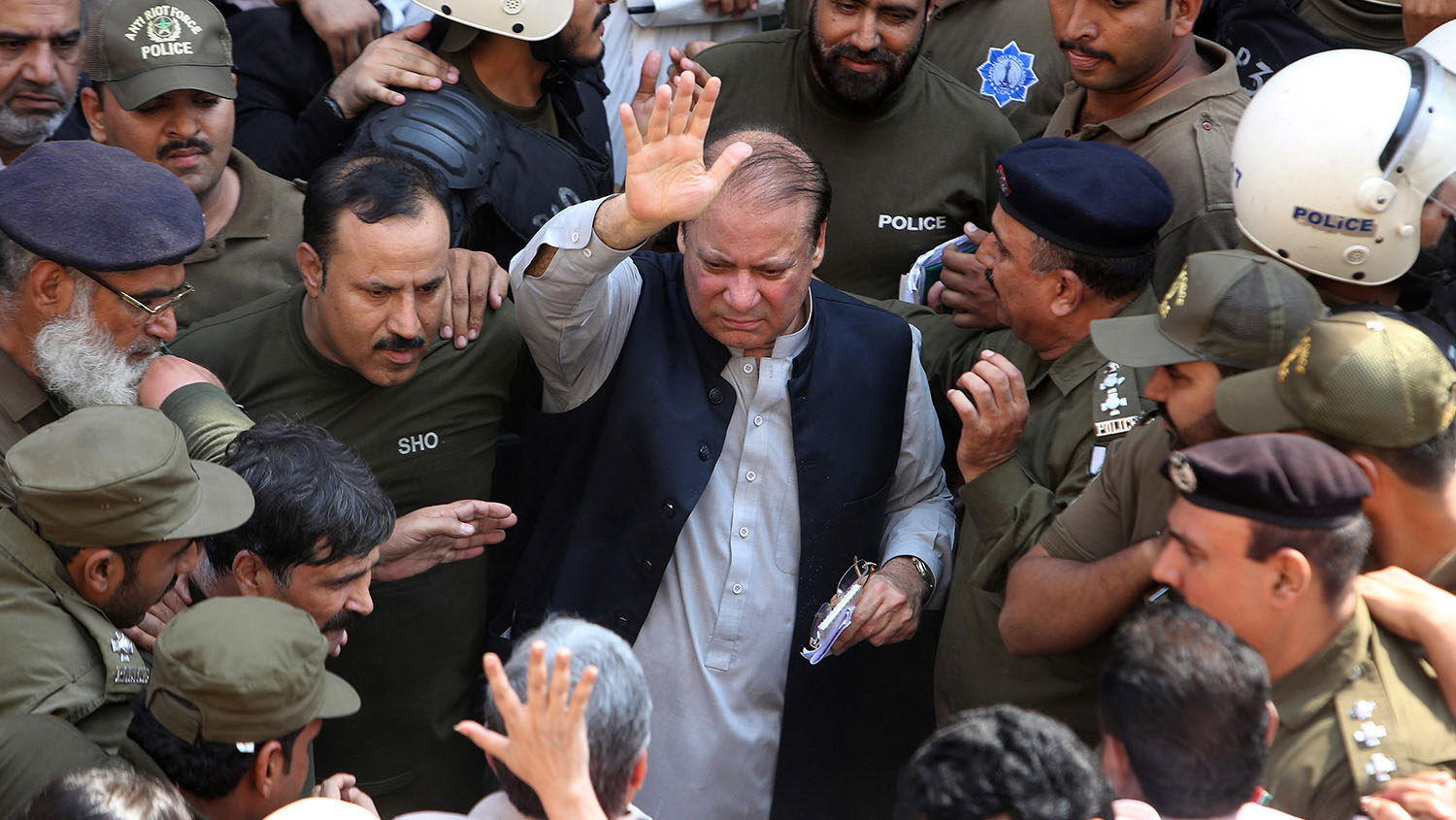 Police escort jailed former Pakistani prime minister Nawaz Sharif, center, as he leaves the accountability court in Lahore on Oct. 11, 2019. (AFP)