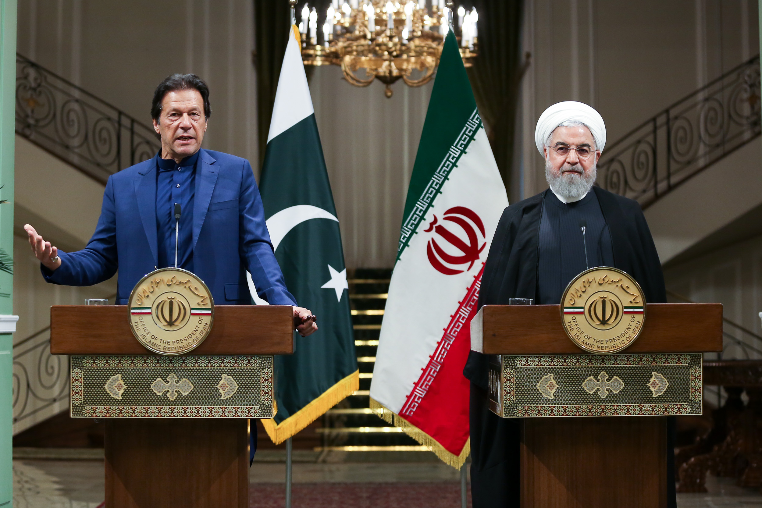 A handout picture provided by the Iranian Presidency on October 13, 2019 shows President Hassan Rouhani (R) and Pakistan's Prime Minister Imran Khan giving a joint press conference in the Iranian capital Tehran. (AFP)