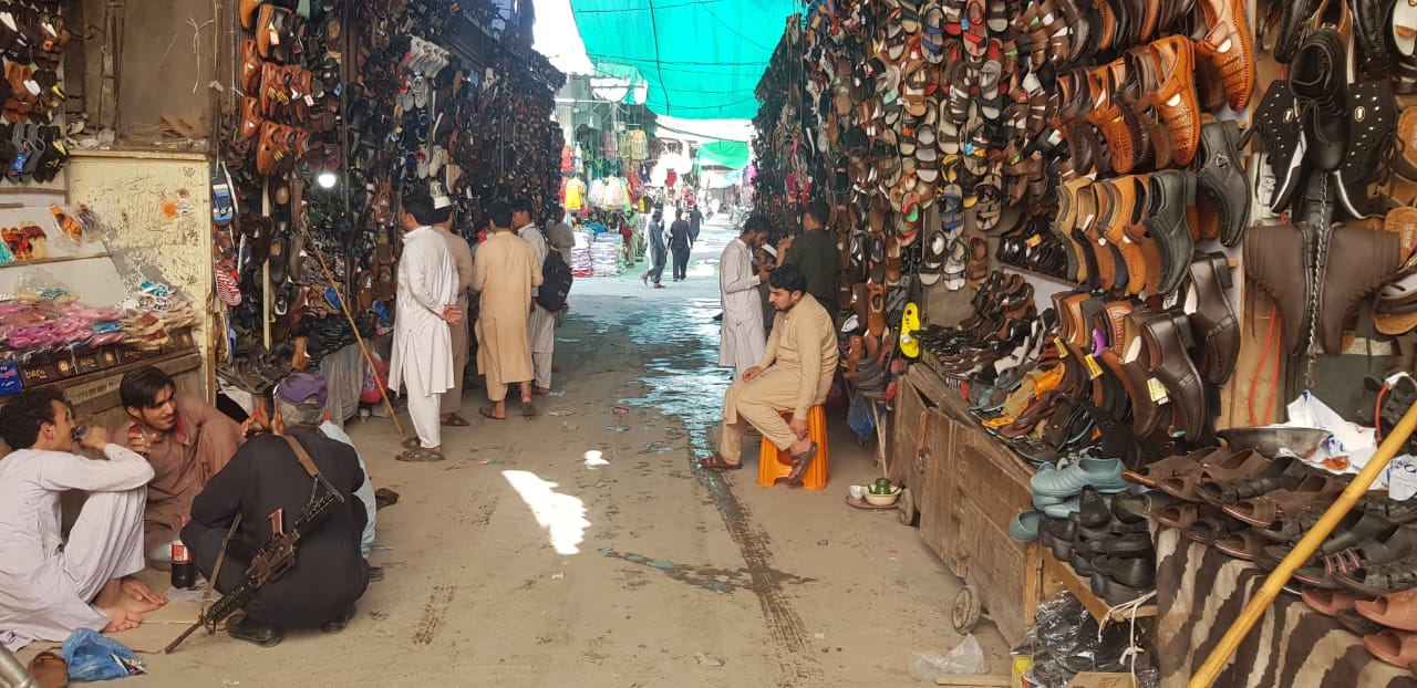 Customers look at shoes at the sprawling Afghan Market in Pakistan’s Peshawar city on Thursday, October 10, 2019. (Arab News photo)