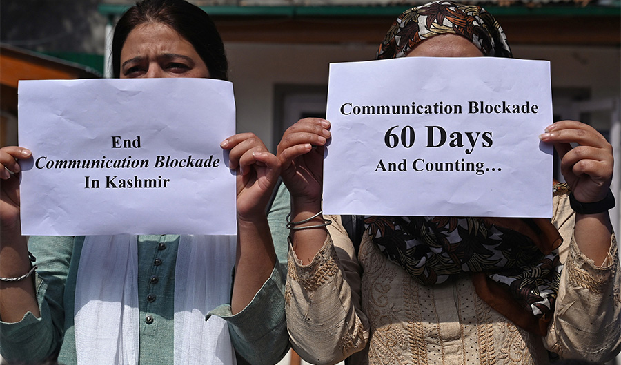 In this file photo taken on October 3, 2019, journalists hold signs during a protest against the ongoing restrictions of the Internet and mobile phone networks at the Kashmir Press Club during a lockdown in Srinagar. (File/ AFP)