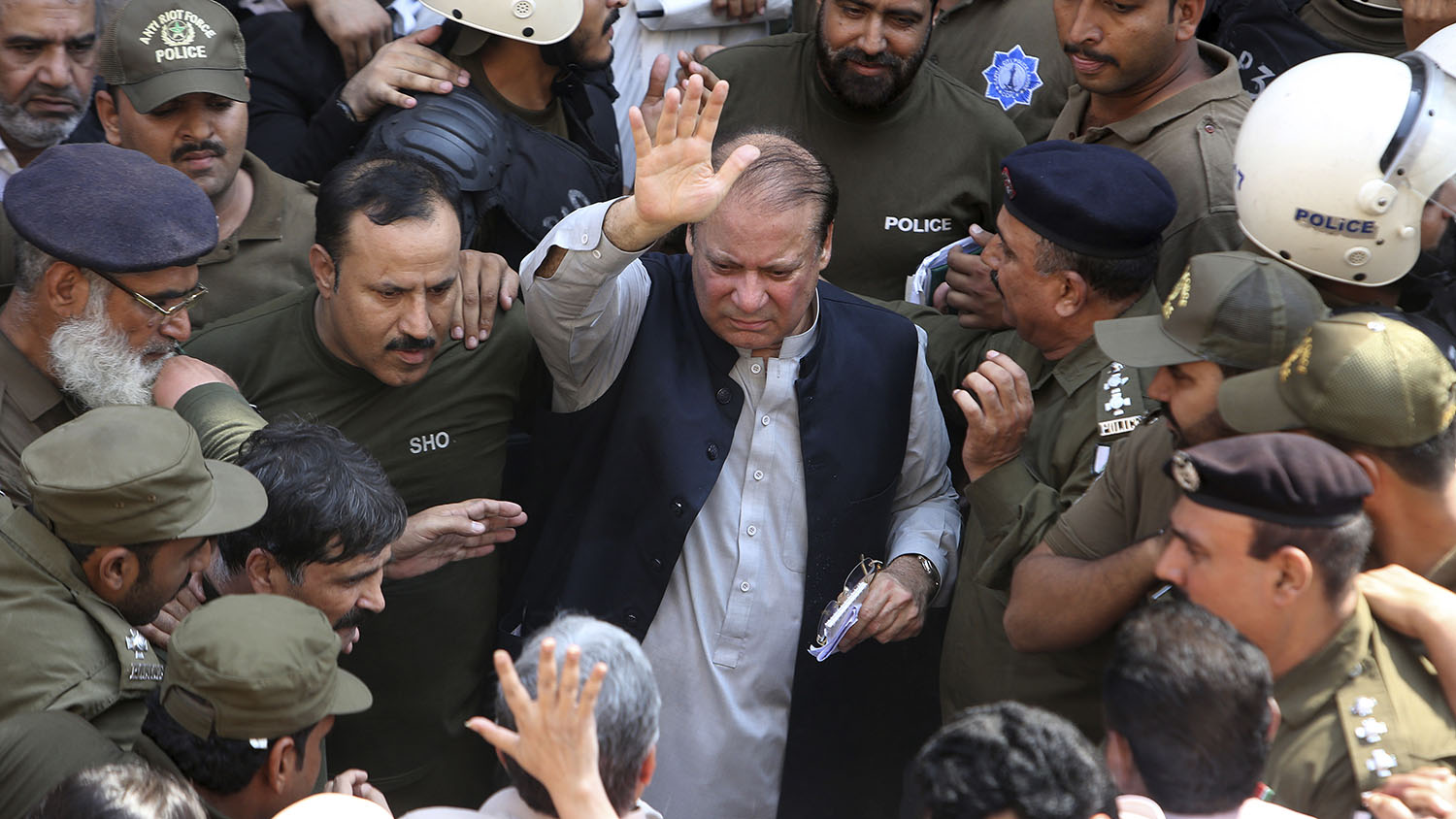 Police escort jailed former Pakistani prime minister Nawaz Sharif, center, as he leaves the accountability court in Lahore on Oct. 11, 2019. (AFP)