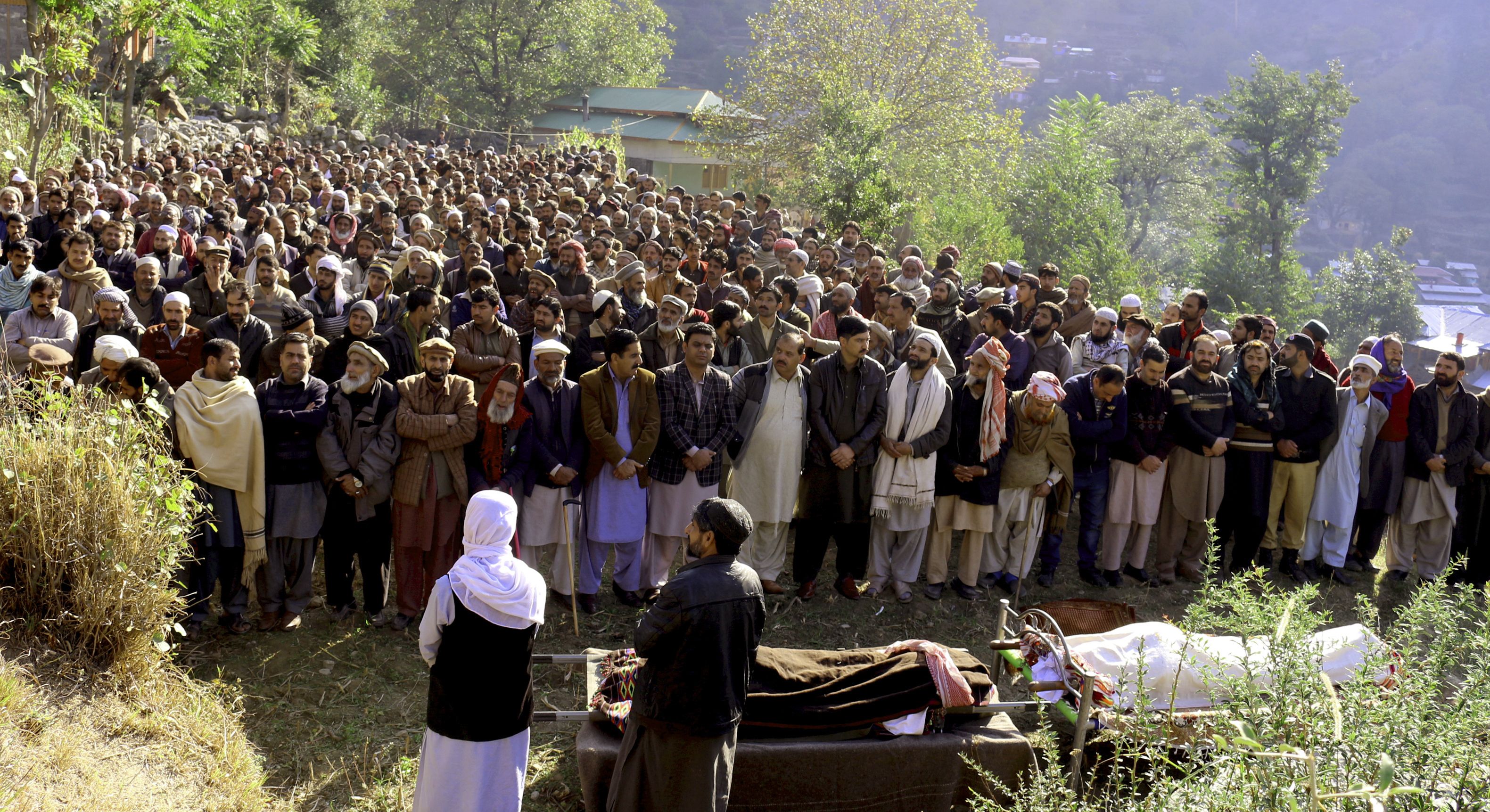 Pakistani Kashmiri villagers gather to offer funeral prayers of father and son who were reportedly killed by Indian shelling in Neelum valley situated at the Line of Control between Pakistan and India, Friday, Oct. 25, 2019. Pakistan and India traded fire in disputed Kashmir killing many people on both sides, officials said. (AP Photo/M.D.Mughal)