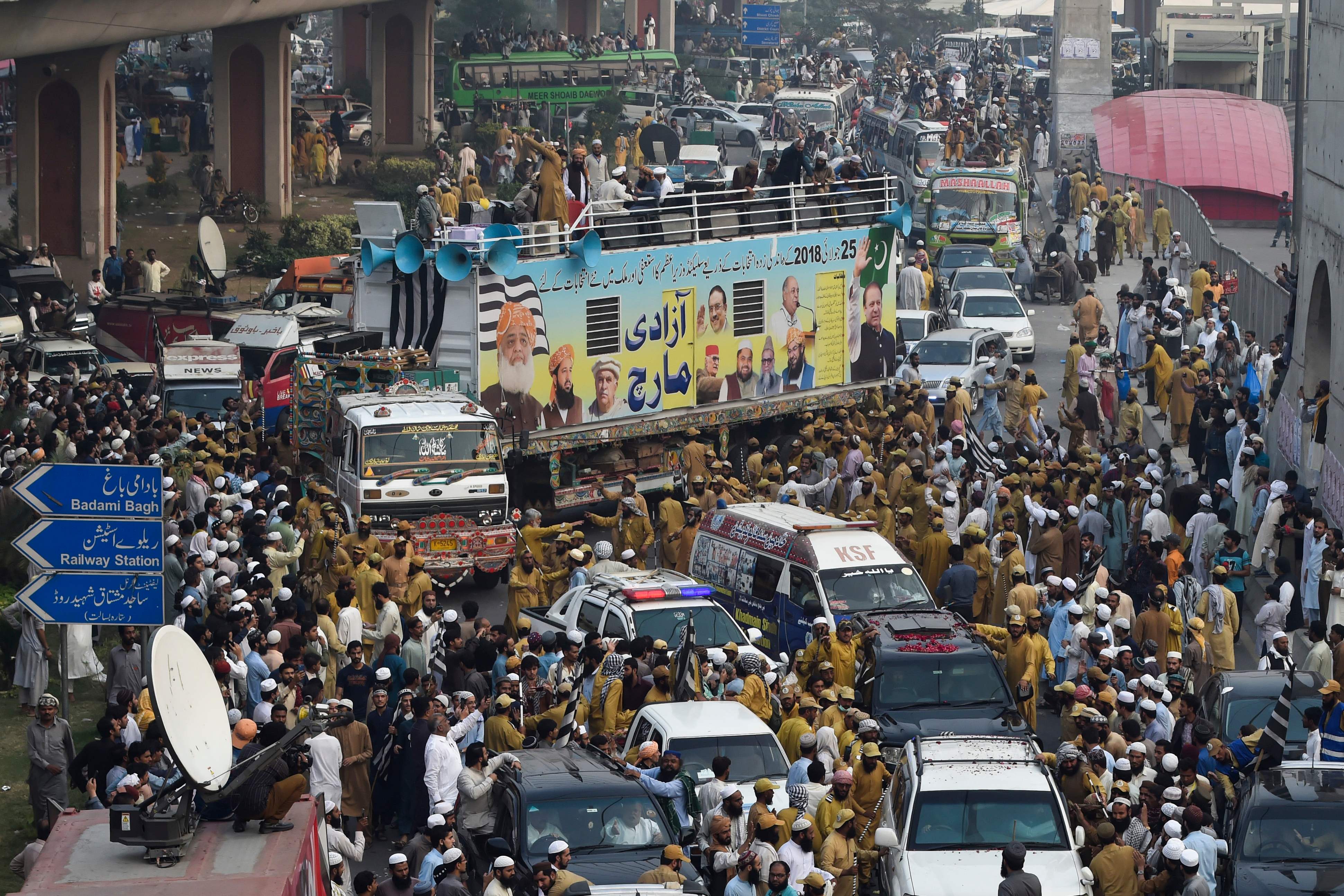 Activists and supporters of the Jamiat Ulema-e-Islam party gather during an anti-government "Azadi March" towards Islamabad, in Lahore on October 30, 2019. Pakistan Prime Minister Imran Khan faces the first major challenge to his leadership as a grey-bearded, orange-turbaned rival he calls "Maulana Diesel" marches to Islamabad with thousands of Islamists hoping to bring down the government. (AFP)