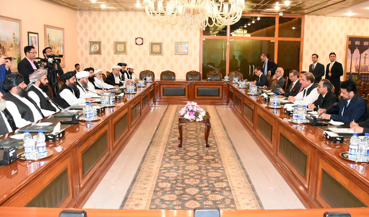 In this photo released by the Foreign Office, Pakistan's Foreign Minister Shah Mehmood Qureshi, fourth from right, heads talks with Taliban delegation at the Foreign Office in Islamabad, Pakistan on Oct. 3, 2019. (Pakistan Foreign Office via AP)