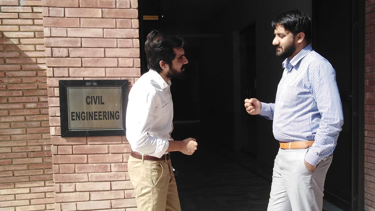 Muhammad Israr Khan (left) talks to his former Lecturer Raja Tasaddiq at COMSATS University Islamabad Wah Campus outside civil engineering department on October 22, 2019. (AN Photo)