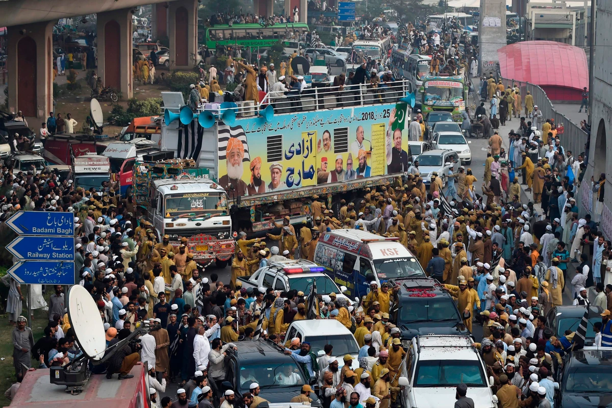 Activists and supporters of the Jamiat Ulema-e-Islam party gather during an anti-government "Azadi March" towards Islamabad, in Lahore on October 30, 2019. Pakistan Prime Minister Imran Khan faces the first major challenge to his leadership as a grey-bearded, orange-turbaned rival he calls "Maulana Diesel" marches to Islamabad with thousands of Islamists hoping to bring down the government. (AFP)