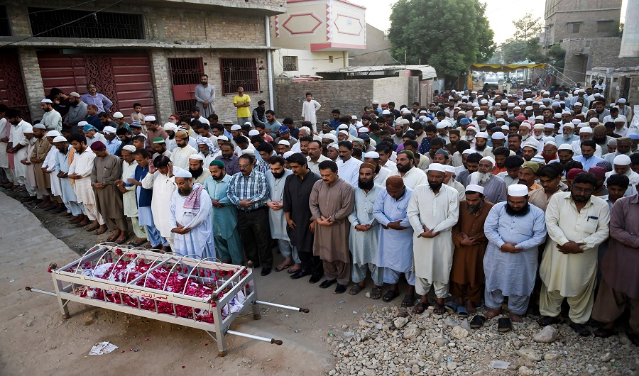 Residents offer a funeral prayer for a train fire victim in Mirpurkhas on November 1, 2019, a day after a passenger train caught on fire in Rahim Yar Khan. Funerals began at dawn in Pakistan on November 1 after a devastating fire ripped through a crowded train carrying religious pilgrims, killing at least 74, with many of the victims resident of one southern town. (AFP)