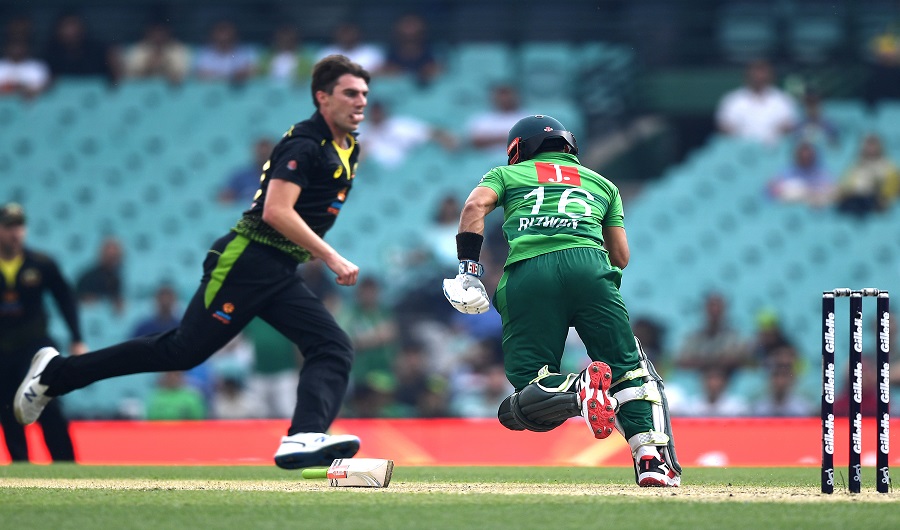 Pakistan's Muhammad Rizwan (R) takes a quick single without his bat off Australia's paceman Pat Cummins (L) during the Twenty20 cricket match between Australia and Pakistan at the Sydney Cricket Ground in Sydney on November 3, 2019. (AFP)
