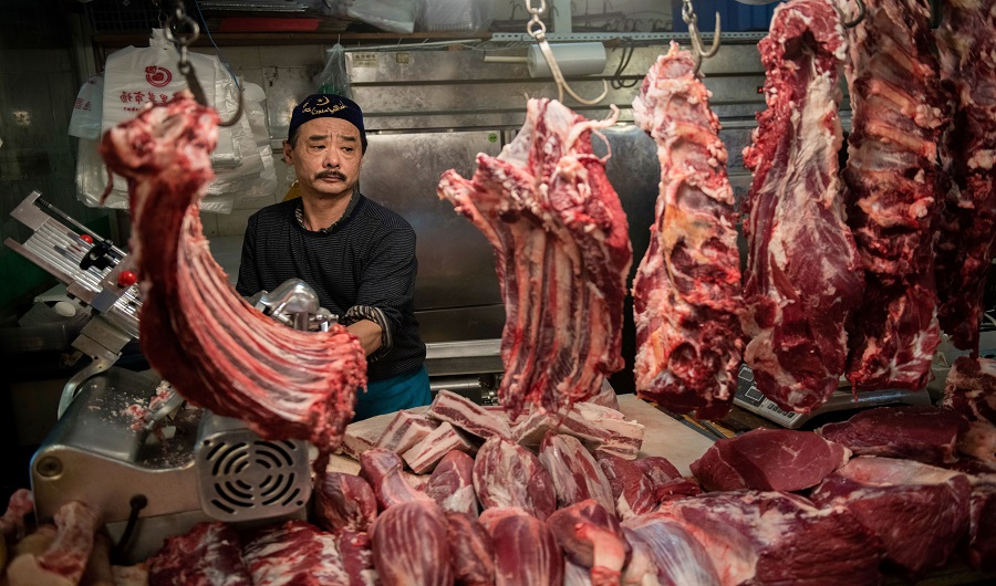 A halal butcher cuts meat in his stall at a market in Beijing on April 4, 2019. (AFP)