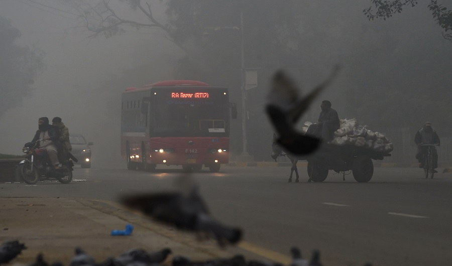 A bus drives on a street amid heavy smog in Lahore on November 12, 2017. (AFP)