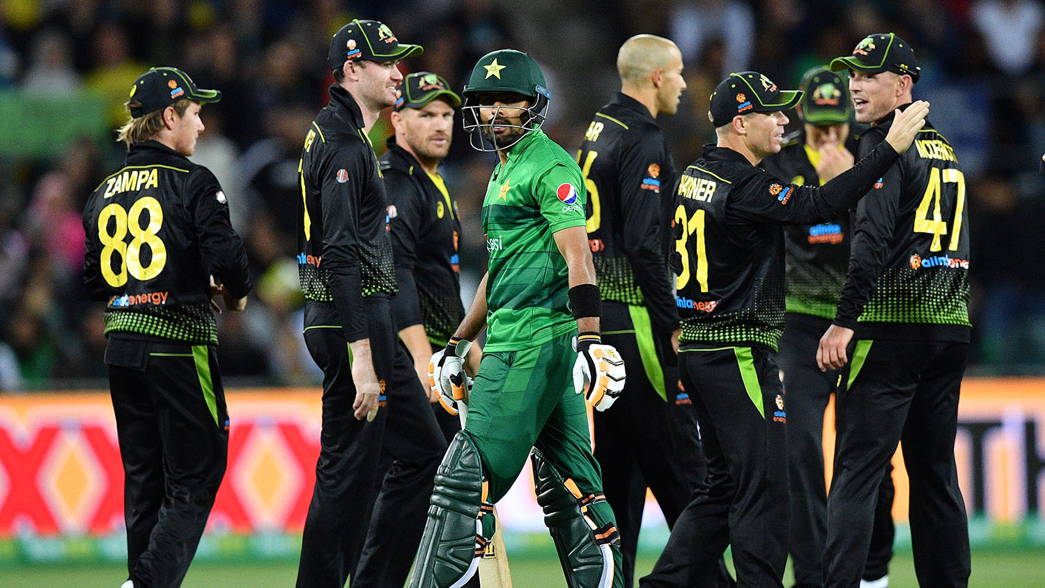 Pakistan's Babar Azam (C) walks back to the pavilion as Australia's player celebrate his dismissal during the second Twenty20 match between Australia and Pakistan at the Manuka Oval in Canberra on Nov. 5, 2019. (AFP)
