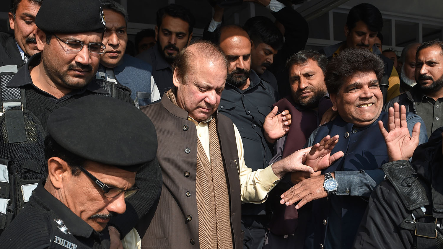In this file photo, former Pakistani prime minister Nawaz Sharif, center, leaves the Supreme Court building after the shrine land case hearing in Islamabad on Dec. 4, 2018. (AFP)