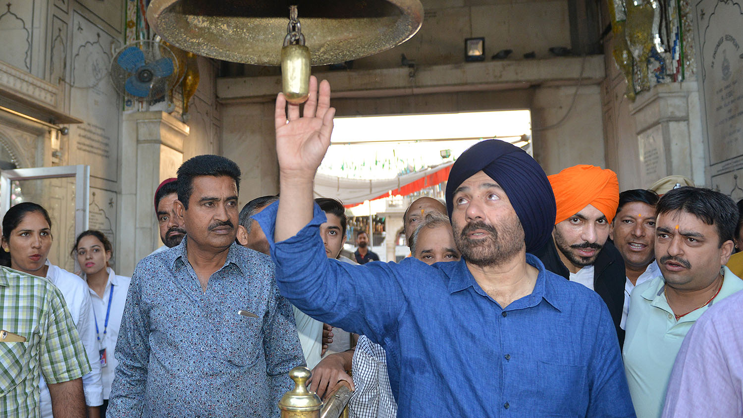 In this file photo, Indian actor Sunny Deol rings a bell as he pays respect at the Durgiana Temple in Amritsar on April 29, 2019. (AFP)