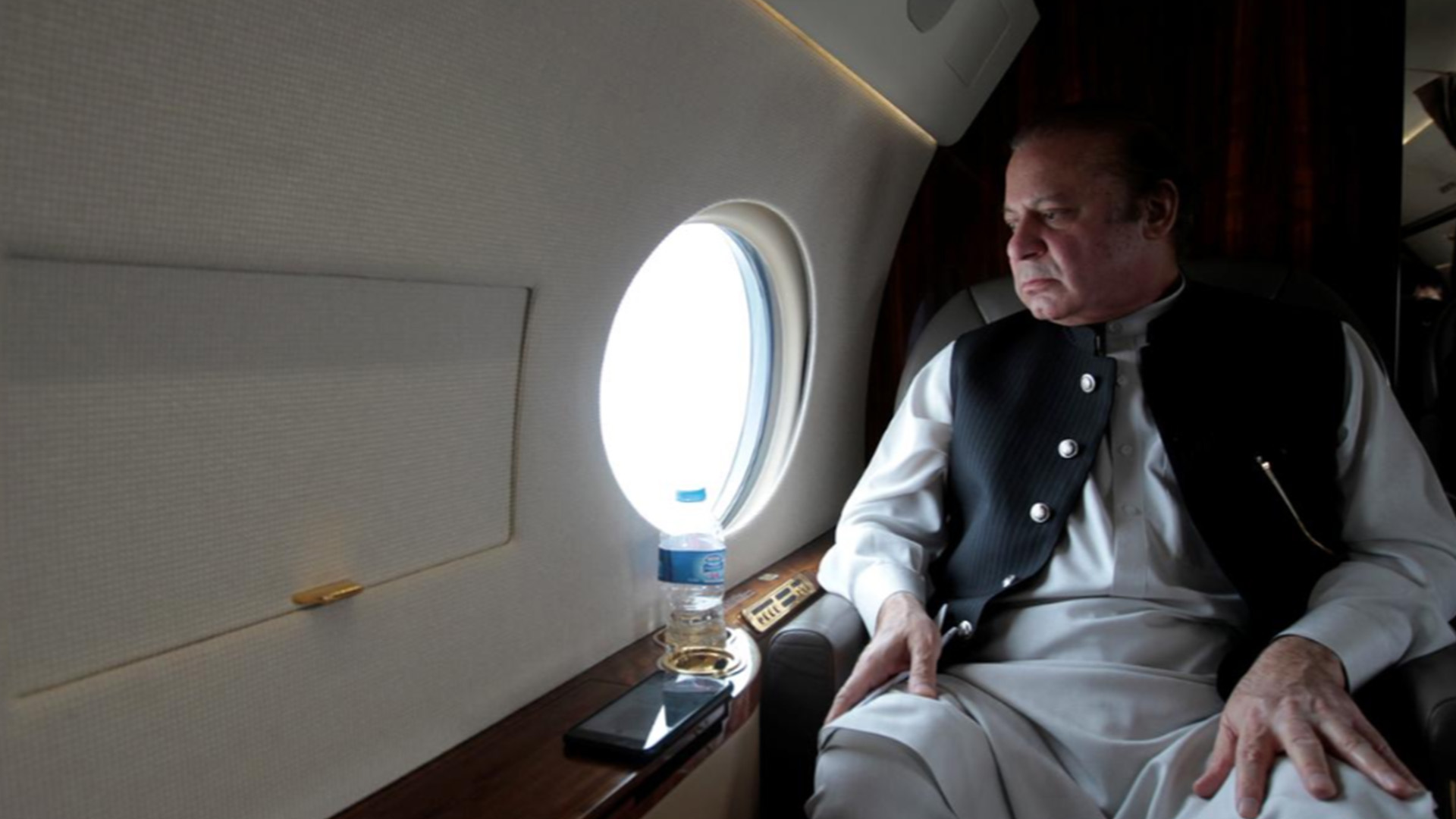 Nawaz Sharif looks out the window of his plane after attending a ceremony to inaugurate the M9 motorway between Karachi and Hyderabad, Pakistan February 3, 2017. (Reuters)