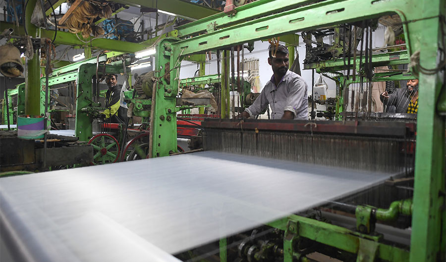 A Pakistan textile labourer works on a power loom in Karachi, on January 25, 2019, the financial capital and the largest industrial city of Pakistan. (AFP)