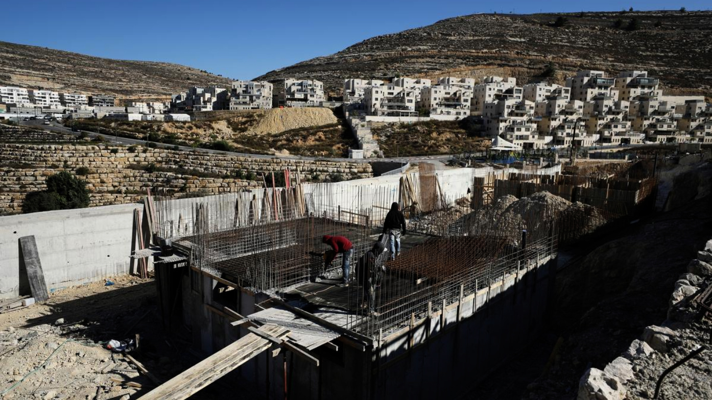 Laborers work at a construction site in the Israeli settlement of Ramat Givat Zeev in the occupied-West Bank on Nov. 19, 2019. (REUTERS)