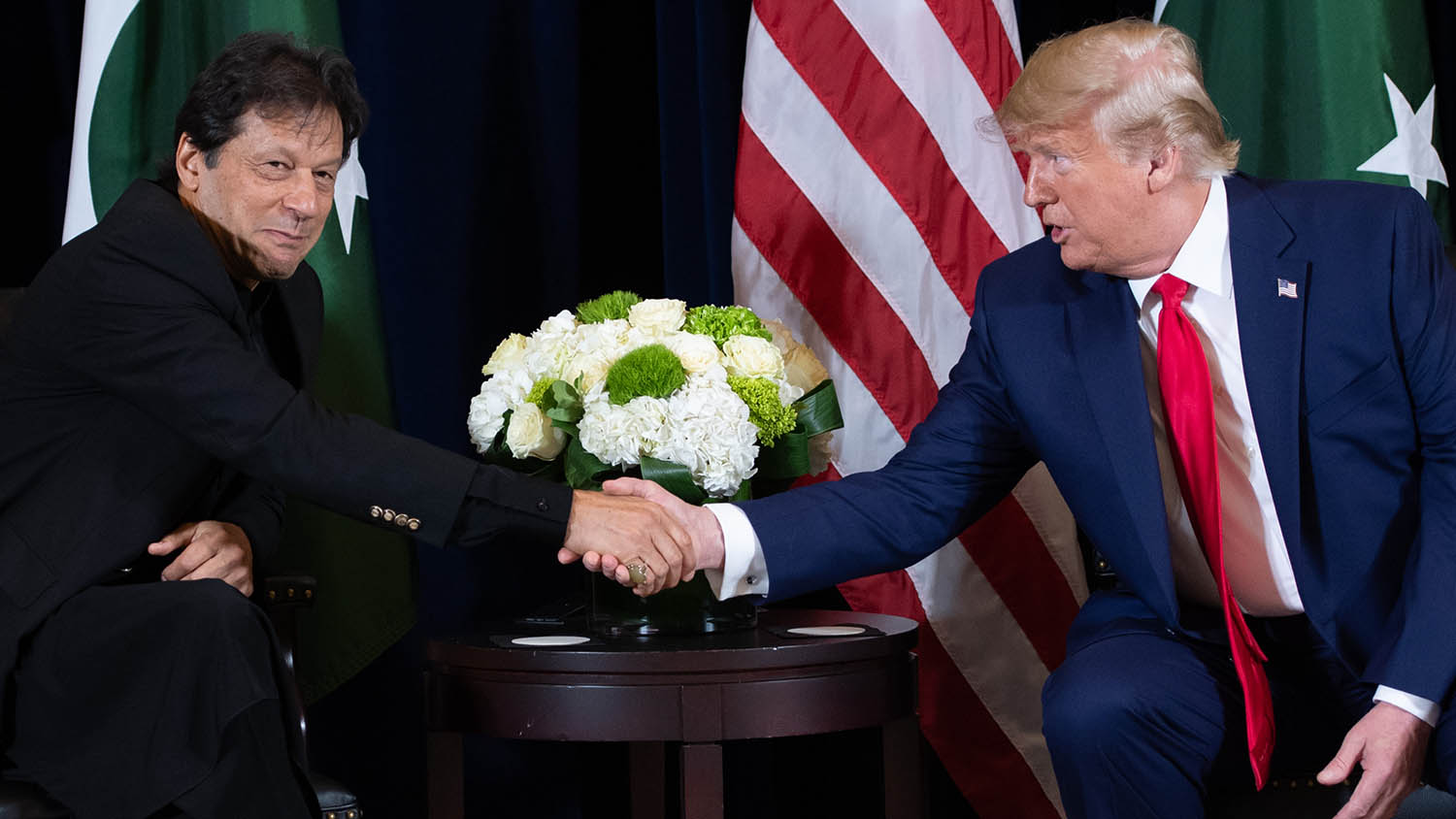 In this file photo, US President Donald Trump, right, shakes hands with Pakistani Prime Minister Imran Khan during a meeting on the sidelines of the UN General Assembly in New York on Sept. 23, 2019. (AFP)