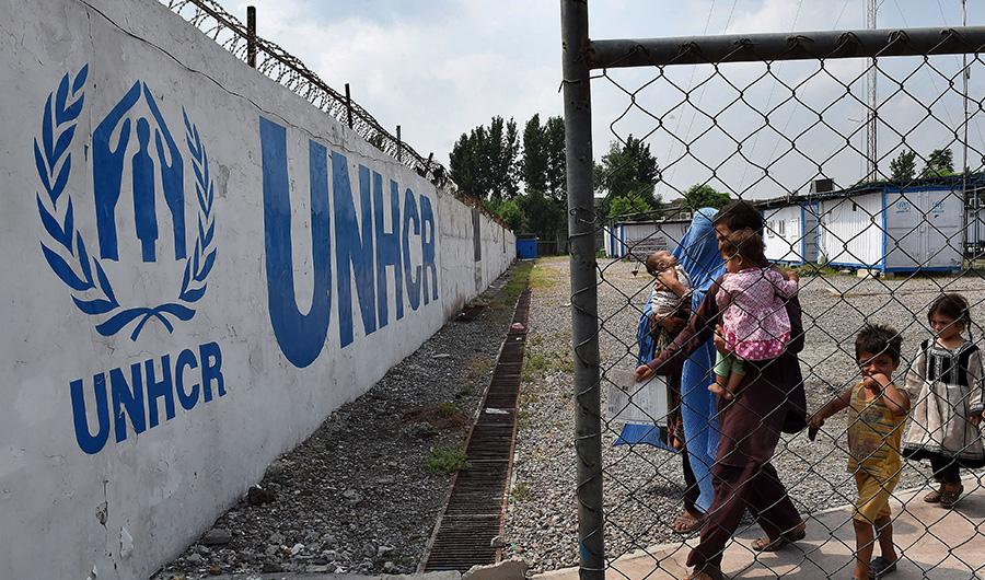 An Afghan refugee family arrives at the United Nations High Commissioner for Refugees (UNHCR) repatriation centre on the outskirts of Peshawar on July 28, 2016. (AFP)