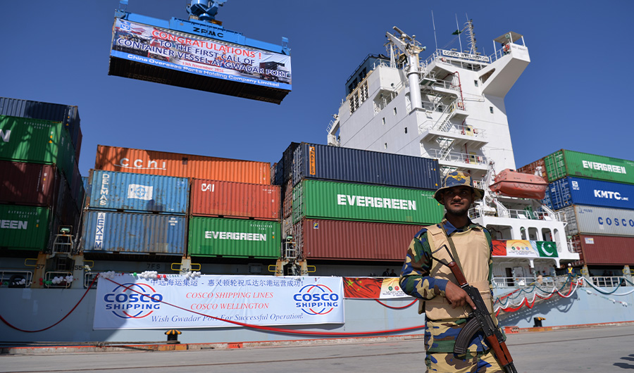 A Pakistani Naval personnel stands guard beside a ship carrying containers during the opening of a trade project in Gwadar port, some 700 kms west of Karachi on November 13, 2016. (AFP)